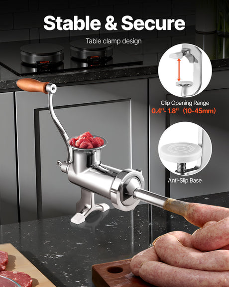 Stainless steel hand crank meat grinder clamped to a benchtop