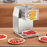 Electric meat slicer set up on a commercial kitchen bench