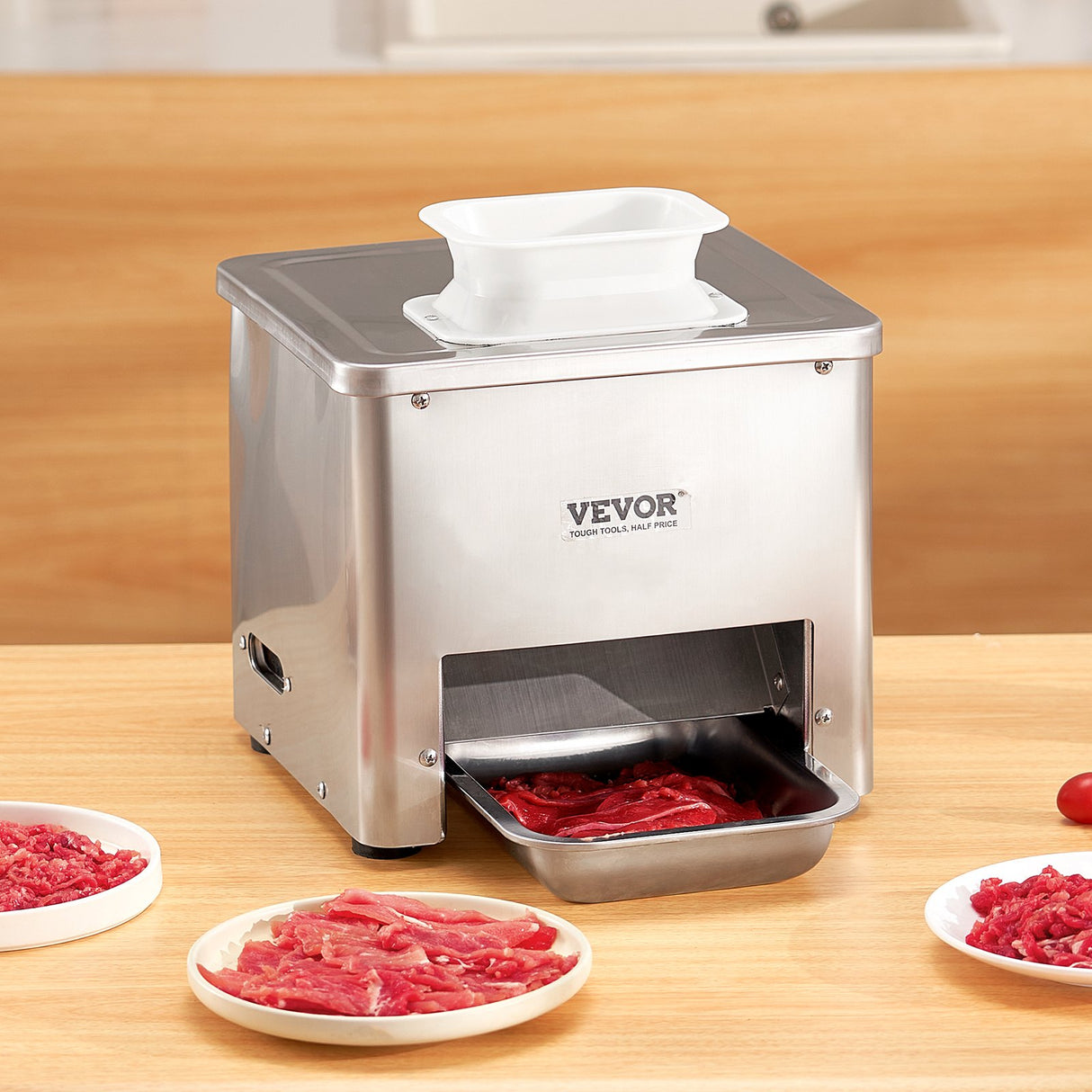 Meat slicer in use on a kitchen bench with fresh meat