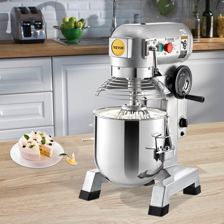 Commercial stand mixer kneading pizza dough in a bakery kitchen