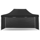 Black 3 x 6 m portable gazebo with sidewalls fitted, set up on grass