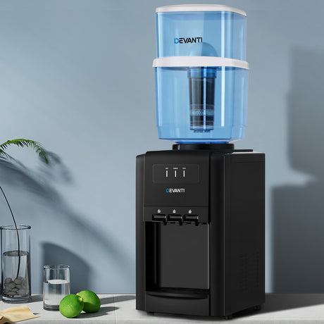 Water dispenser set up on a kitchen benchtop with a glass of water