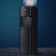 Black floor standing water cooler dispenser with hot and cold taps and storage cabinet