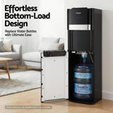 Water bottle being slid into the base of the black bottom loading dispenser