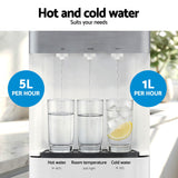 White three tap water dispenser standing in an office breakroom
